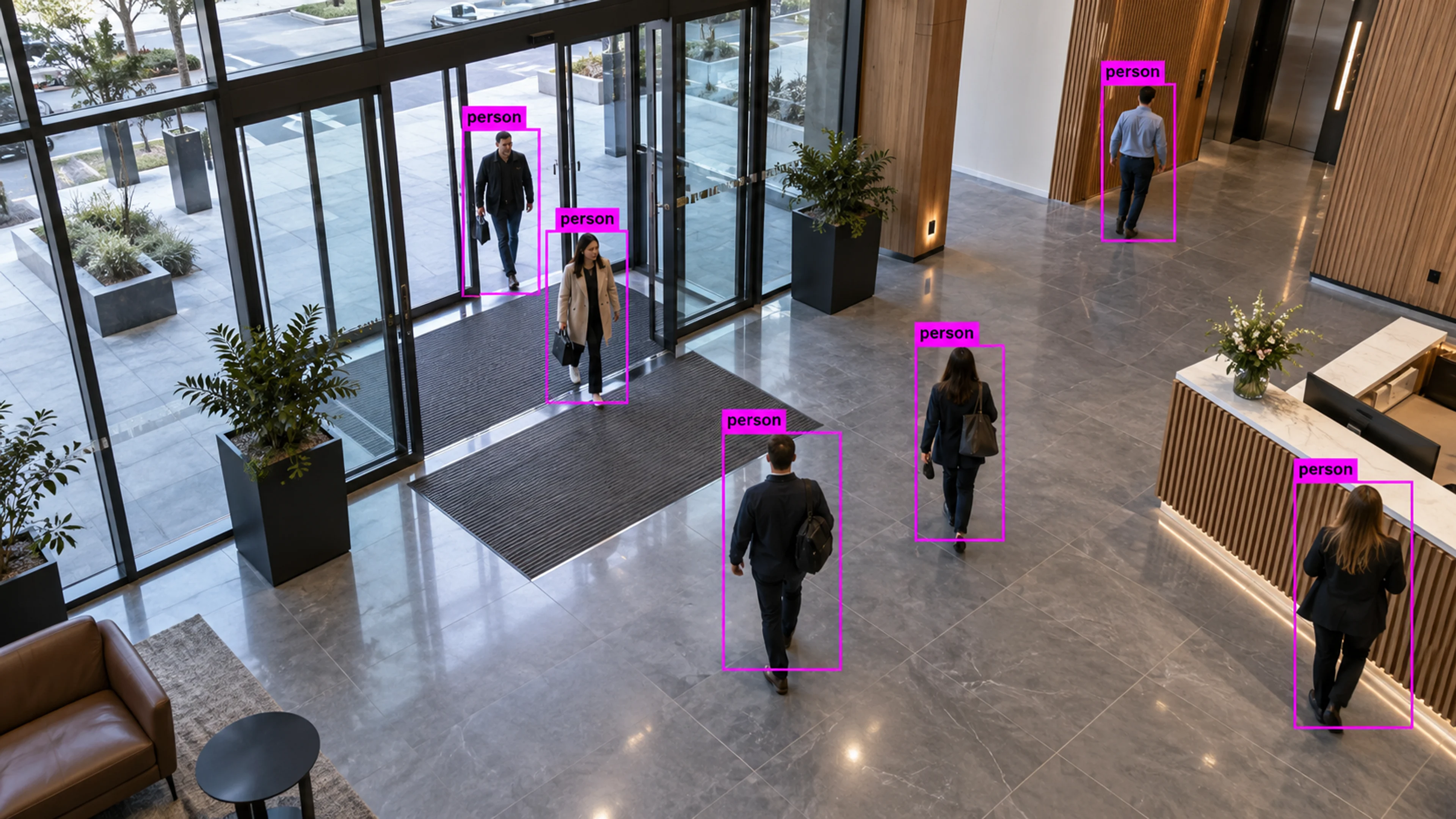 Commercial building circulation area with people walking through the entrance. Illustrative object detections.
